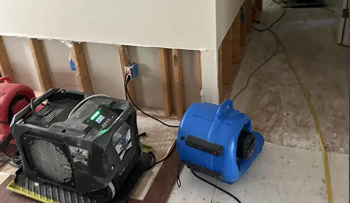 Air mover and dehumidifier drying flood-cut drywall in a Redmond room