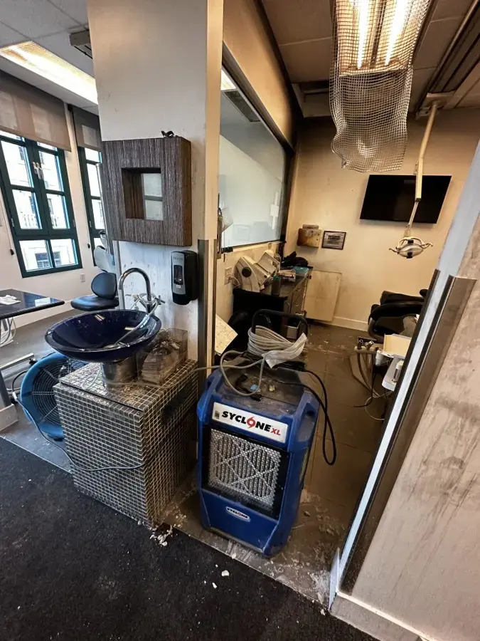 Commercial dehumidifier drying a water-damaged Redmond business interior